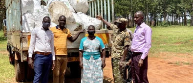 The District vice chairperson (blue dress) , Deputy RDC(left) with the principle Agric officer  receiving cuttings from supplier.